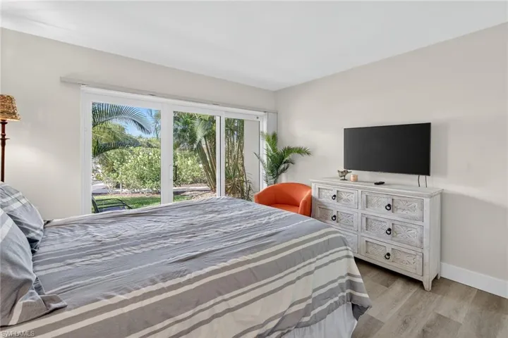 Bedroom with wood finished floors and access to outside