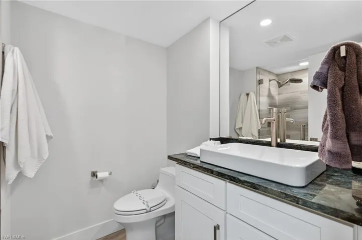 Bathroom with vanity, a shower, and recessed lighting