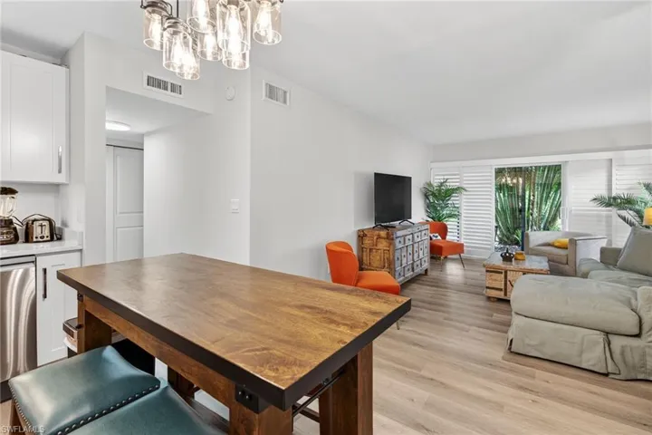Dining space featuring light wood finished floors and a chandelier