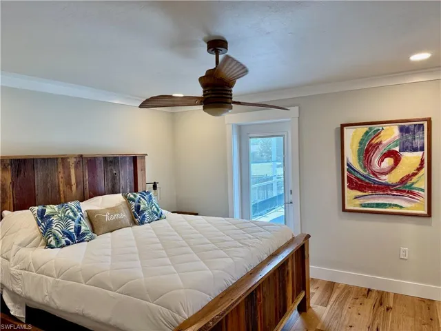 Hardwood flooring, crown molding, recessed lighting, ceiling fan, and French door
