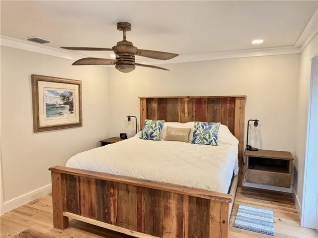 Wood-finish flooring, recessed lighting, crown molding, and a ceiling fan with light fixture