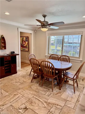 Recessed lighting, crown molding, ceiling fan with light, tiled flooring, and large window