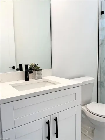Full bathroom featuring vanity and toilet