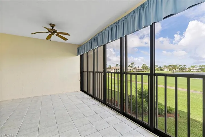 Unfurnished sunroom featuring ceiling fan