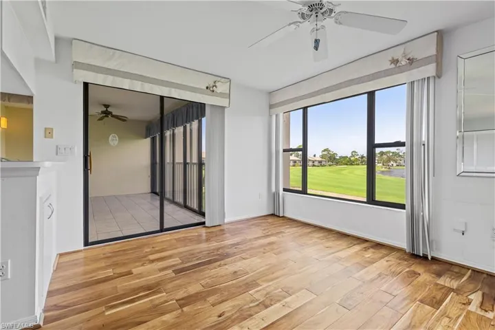 Empty room with light hardwood / wood-style flooring and ceiling fan