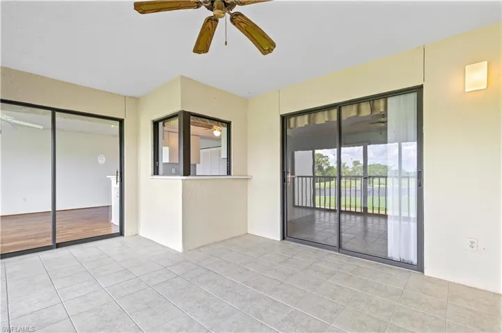 Tiled empty room with ceiling fan