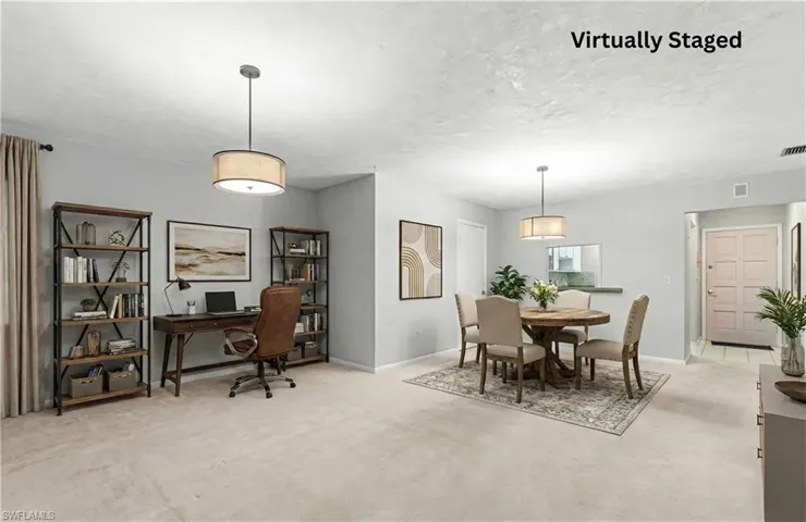 Dining room featuring light colored carpet, a desk, and a textured ceiling