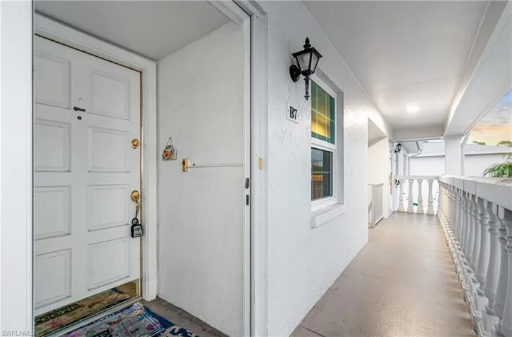 Doorway to property featuring stucco siding