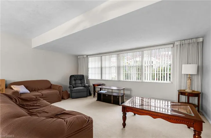 Living room featuring healthy amount of natural light and carpet