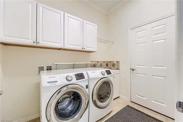Upgraded washer and dryer with laundry sink, cabinetry...oh, and crown molding