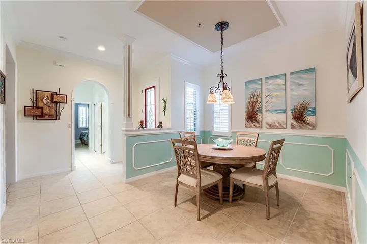 Tiled dining area with custom molding and finishes