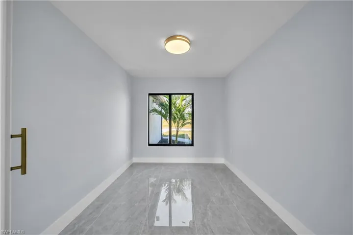 Empty room featuring baseboards and light marble finish floors