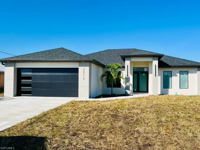Prairie-style home with stucco siding, roof with shingles, and concrete driveway