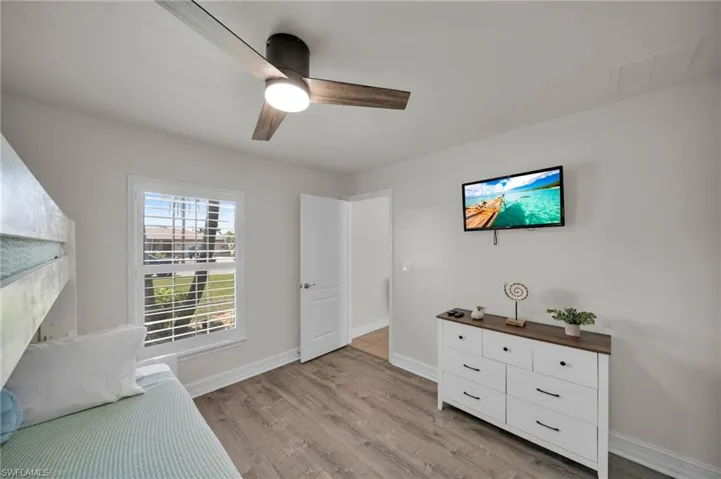 Unfurnished room featuring a ceiling fan, visible vents, baseboards, and light wood-type flooring