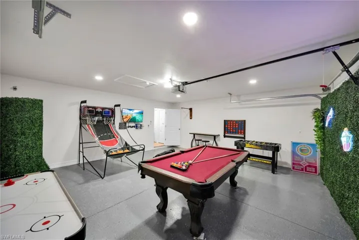 Rec room with baseboards, recessed lighting, a garage, and pool table