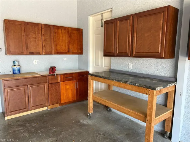 Wood cabinets & a work bench with a granite top.