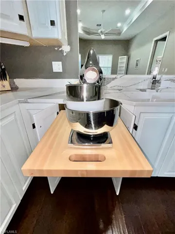 Out when you need it, behind a cabinet door when you don’t so you can keep the exotic Quartz countertops clear too.