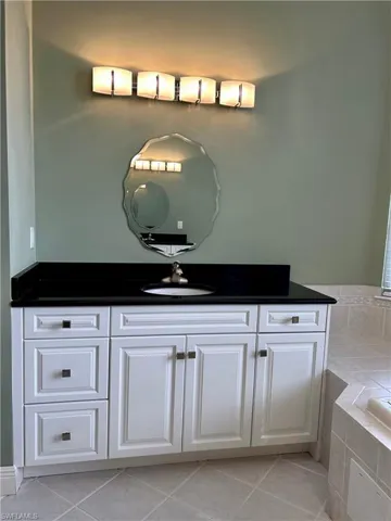 Master Bathroom has split vanities so you have plenty of room when you need it; again with black Quartz countertops.