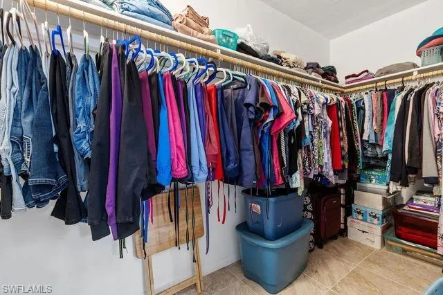 Spacious closet featuring tile flooring