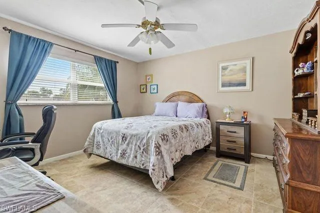 Tiled bedroom with ceiling fan