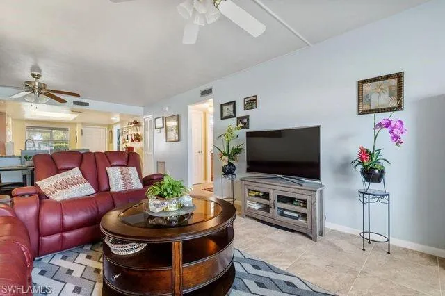 Tiled living room featuring ceiling fan