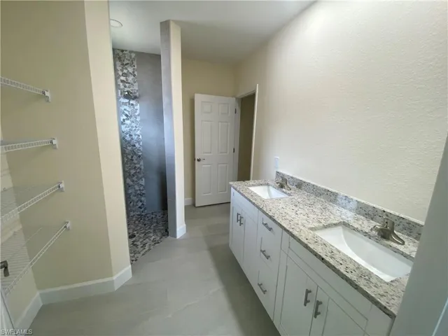 Bathroom with double vanity and walk in shower