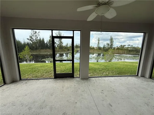 Unfurnished sunroom featuring a water view and plenty of natural light