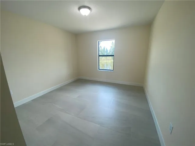 Spare room featuring baseboards