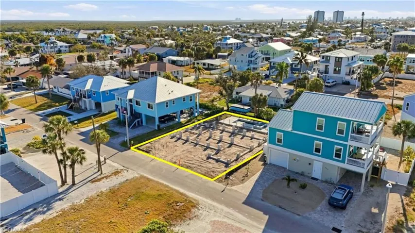 Aerial view of residential area featuring property boundaries highlighted - Virtually Edited Image