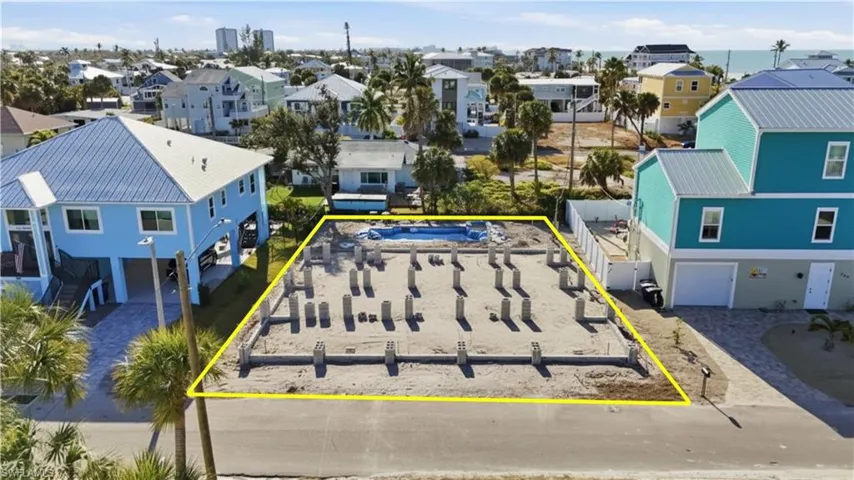 Aerial perspective of suburban area featuring property boundaries highlighted - Virtually Edited Image