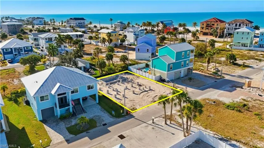 Aerial perspective of suburban area with property parcel outlined and a large body of water - Virtually Edited Image