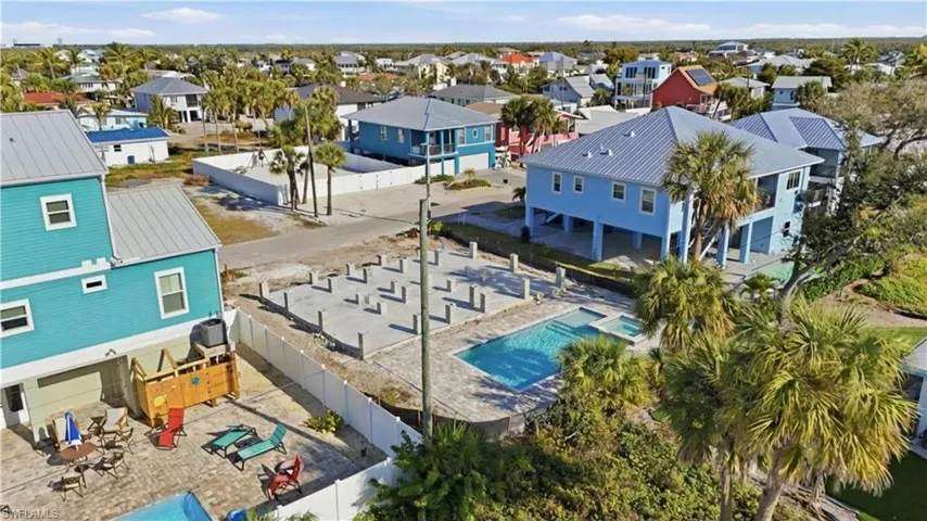Aerial view of residential area featuring a pool area - Virtually Edited Image