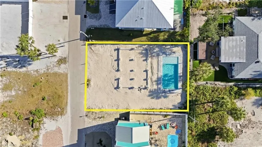 Aerial view of property and surrounding area with property parcel outlined - Virtually Edited Image