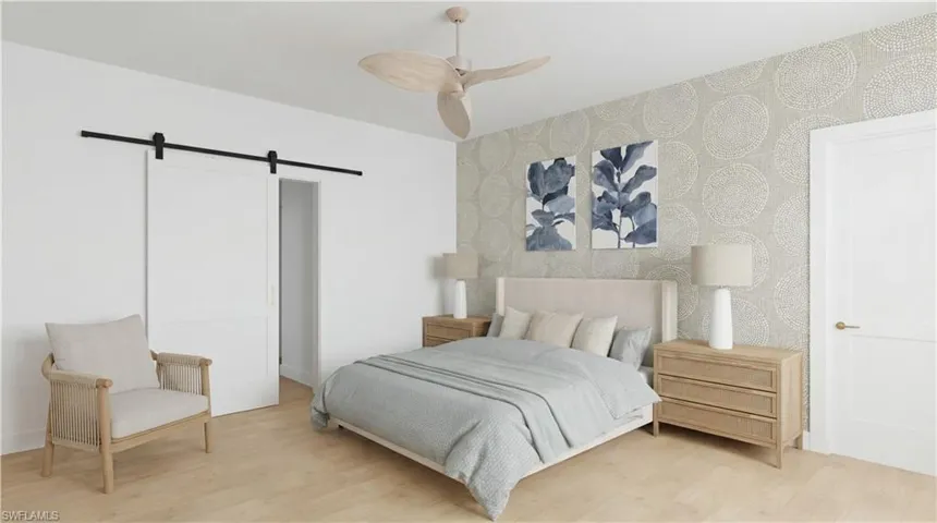 Bedroom with a barn door, wood finished floors, wallpapered walls, and ceiling fan - Virtually Edited