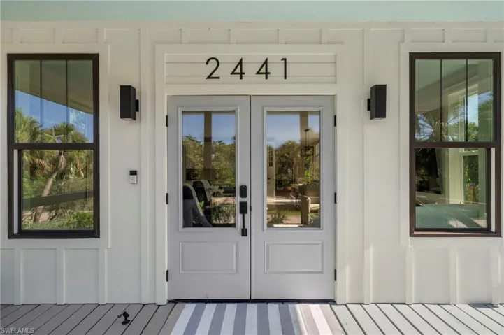 Property entrance with french doors and board and batten siding