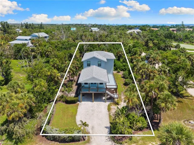 Aerial view of property and surrounding area with property parcel outlined