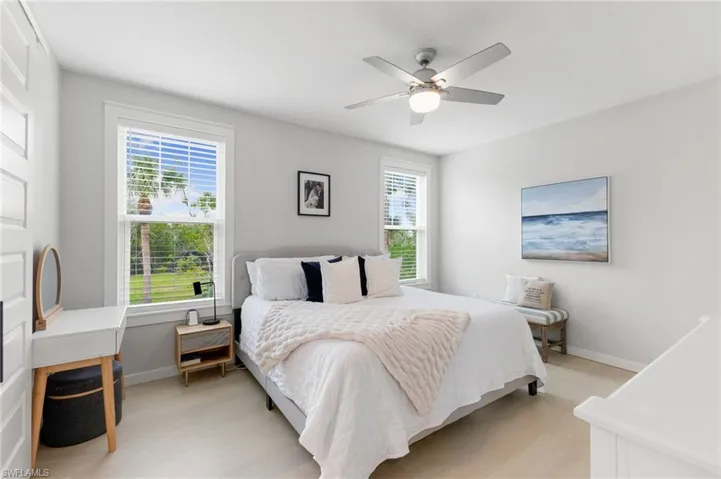 Bedroom with ceiling fan and light wood finished floors