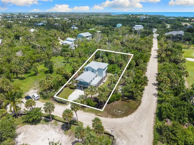 Aerial view of property and surrounding area with property parcel outlined