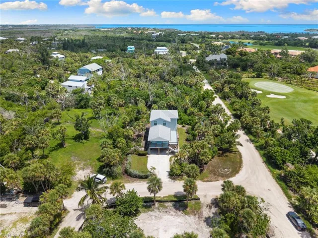 Bird's eye view of a local golf course and a large body of water