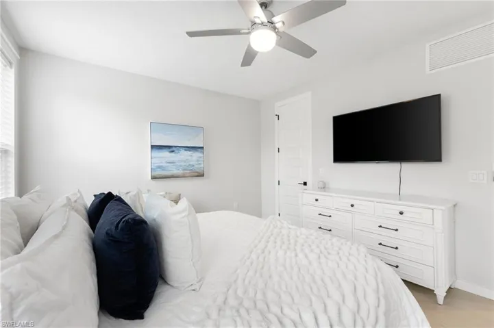 Bedroom with light wood finished floors and a ceiling fan