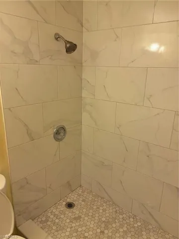 Bathroom featuring toilet and a tile shower