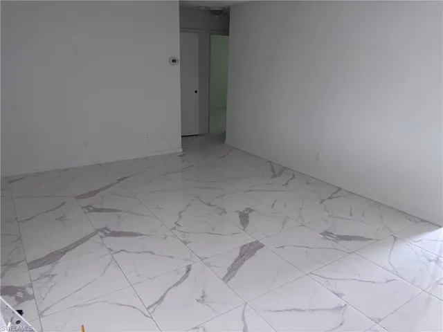 Unfurnished room featuring light marble finish flooring