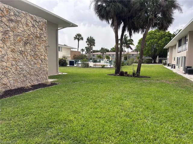 View of green lawn with central air condition unit