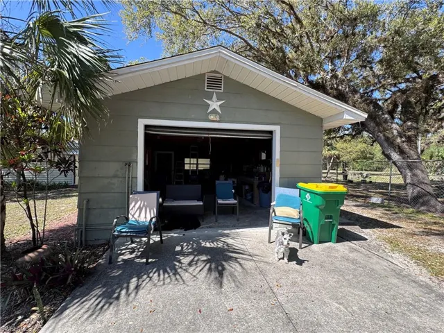 Detached garage with driveway and fence