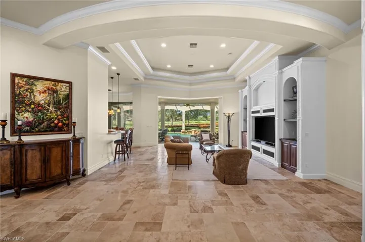 Grand, light-filled great room featuring soaring ceilings, elegant architectural details, and seamless views of the outdoor living area.