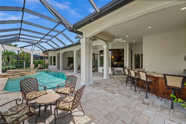 Expansive covered lanai offering multiple seating and dining areas