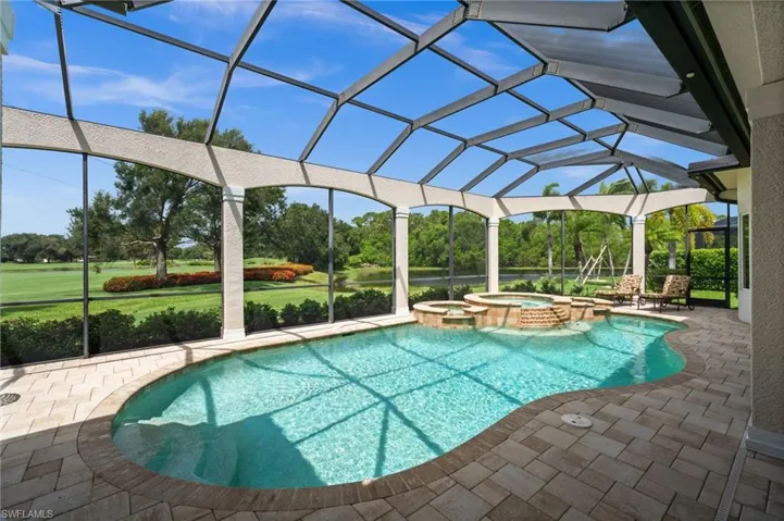 Expansive screened lanai featuring a sparkling pool and spa