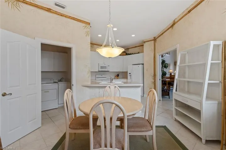 Dining space with washing machine and clothes dryer, light tile patterned floors, and recessed lighting