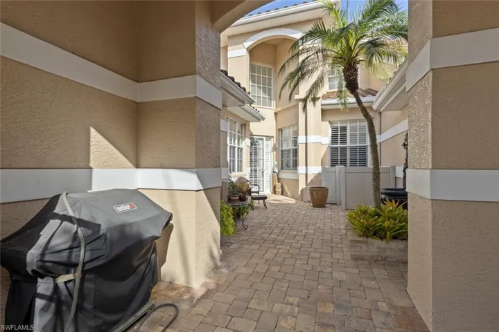View of patio with a grill