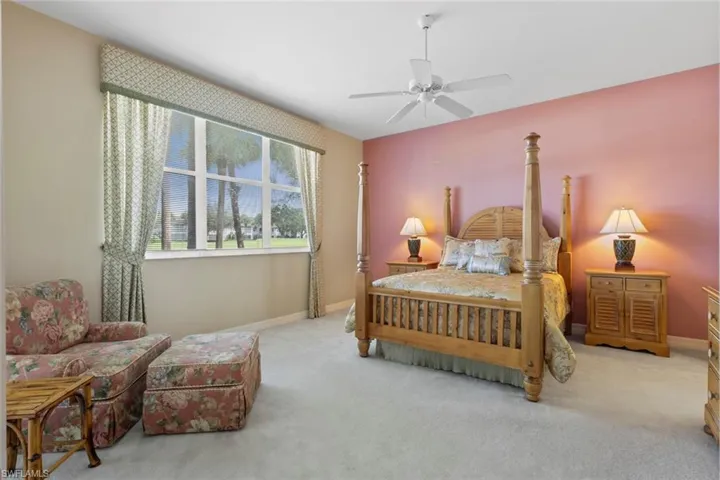 Carpeted bedroom with baseboards and ceiling fan